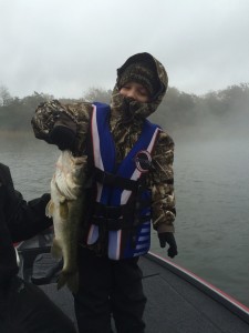 A cold, wet, and windy day didn't keep this little man off the water, and he was rewarded with a nice bass!